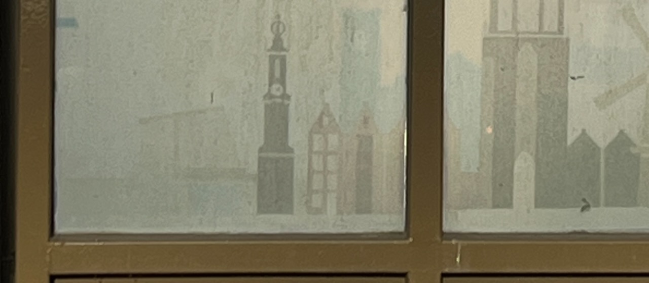 An detail of a window with stickers on it.