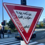 A road sign with a handwritten message that says Nine to five for life